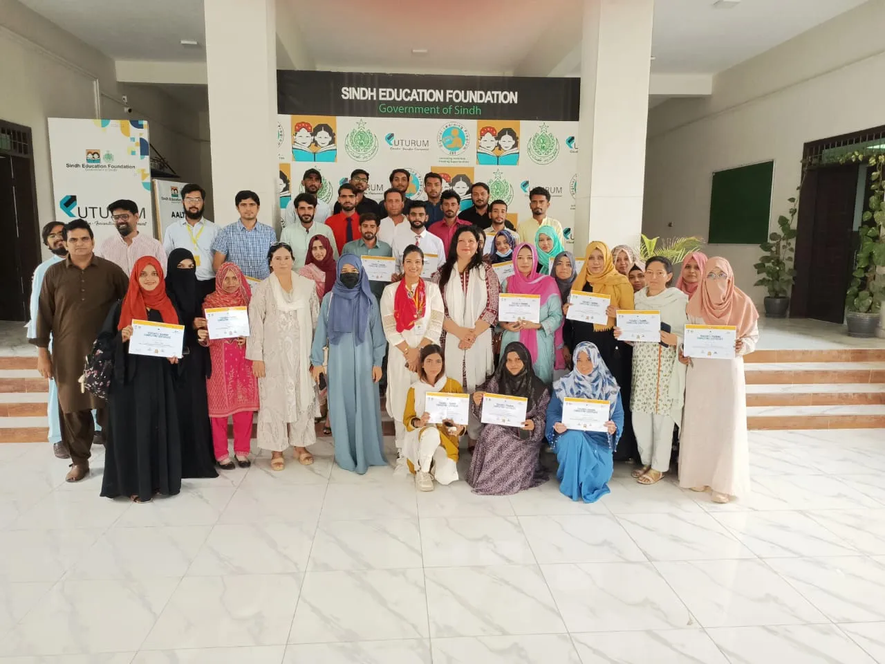 Teachers with their certificates after training at the Sindh Education Foundation