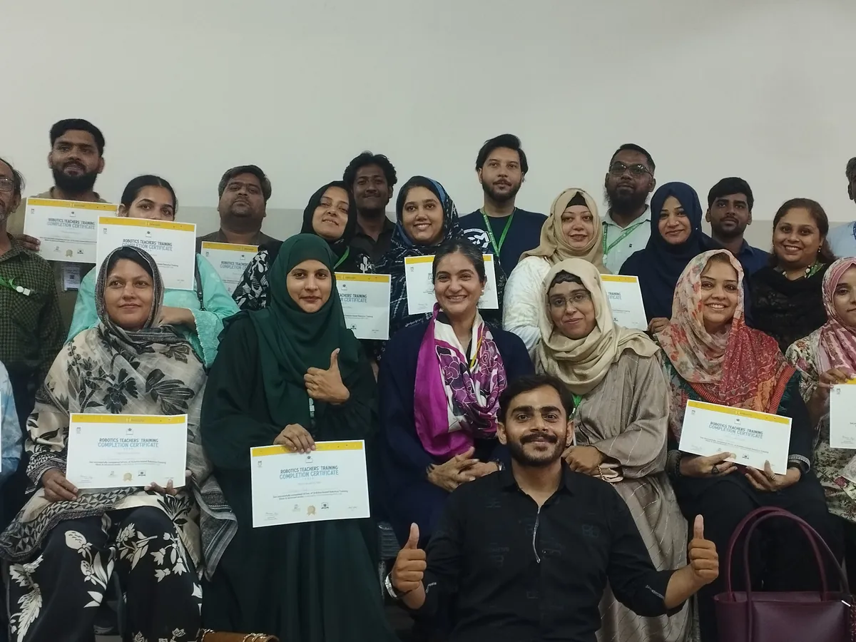 Teachers holding certificates after robotics training