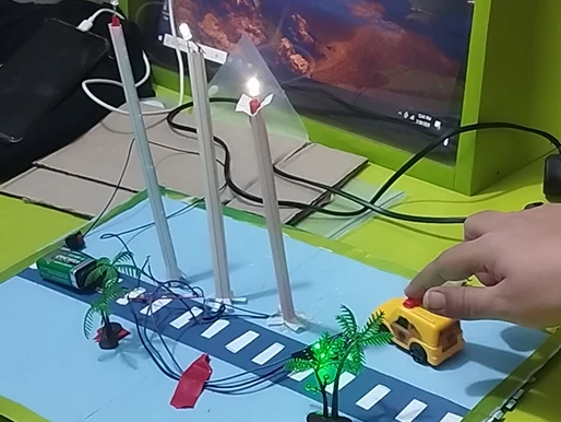A smart street light model with working LEDs, a road and a toy car, built during robotics training